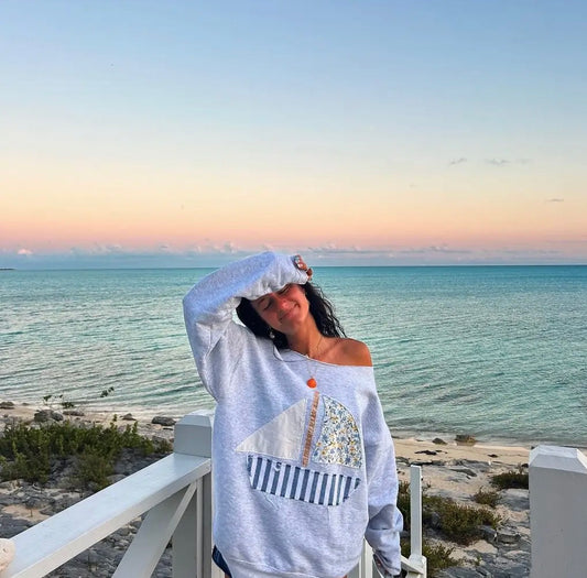 Blue sail boat off the shoulder crew